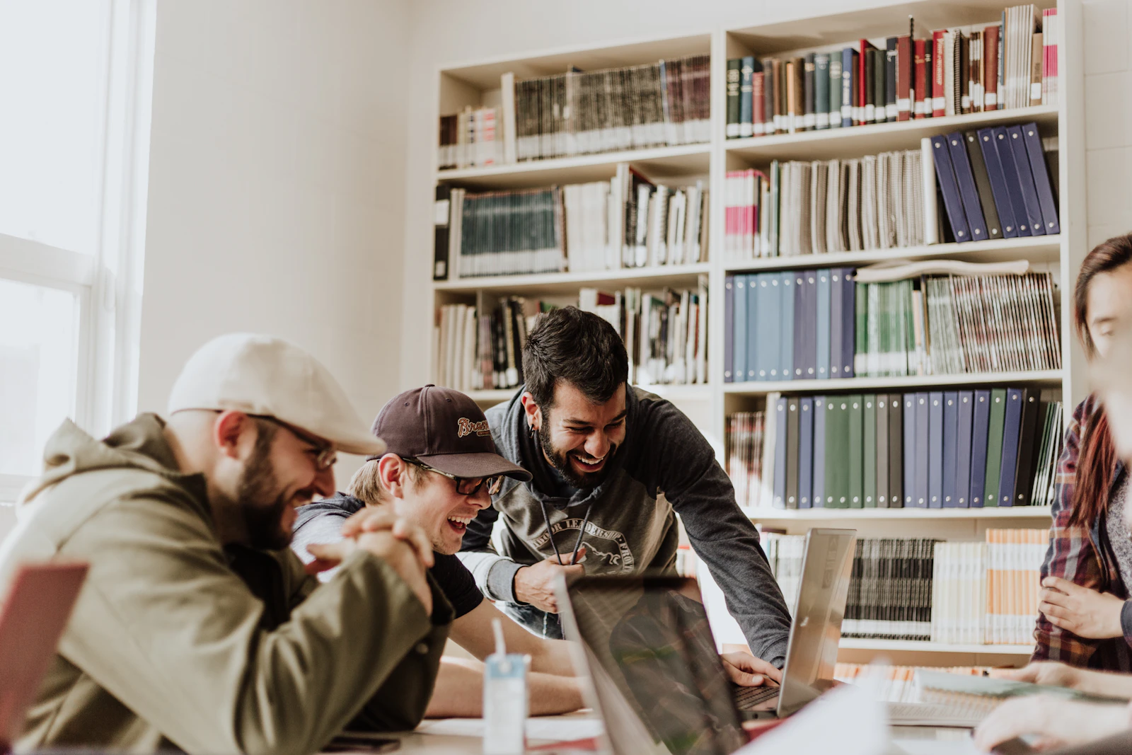 University students collaborating around a table in a campus library