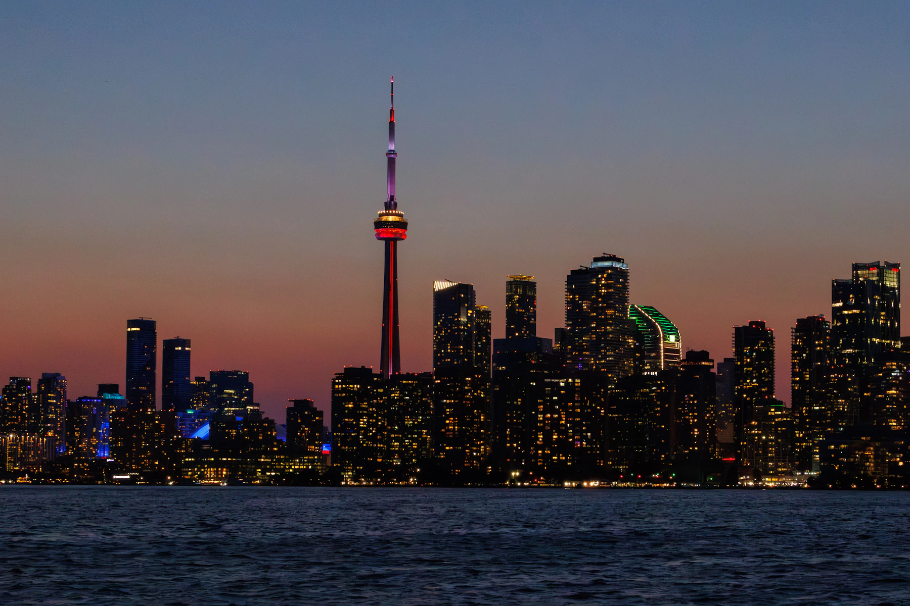 Toronto skyline and CN Tower illuminated at dusk