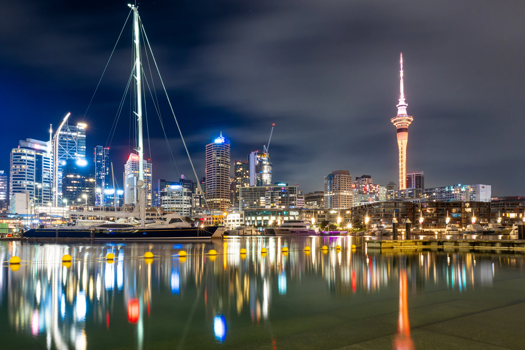 Auckland skyline and Sky Tower reflected in the marina at night